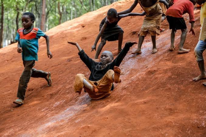 African_Children_Playing_a_Traditional_Sliding_Game